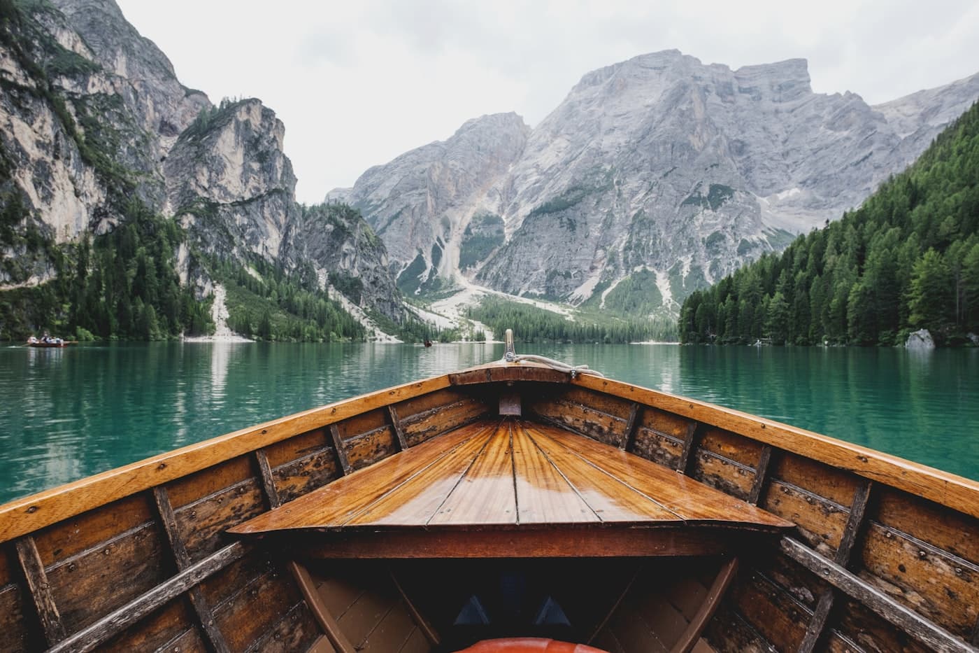 Wooden boat gliding across an alpine lake